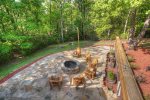 Huge outdoor patio area with fire pit and Adirondack chairs